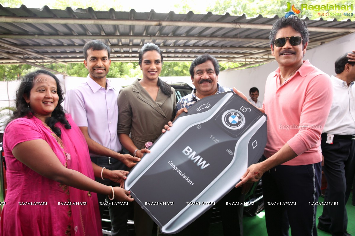 P V Sindhu Receives a BMW Car by V Chamundeswara Nath